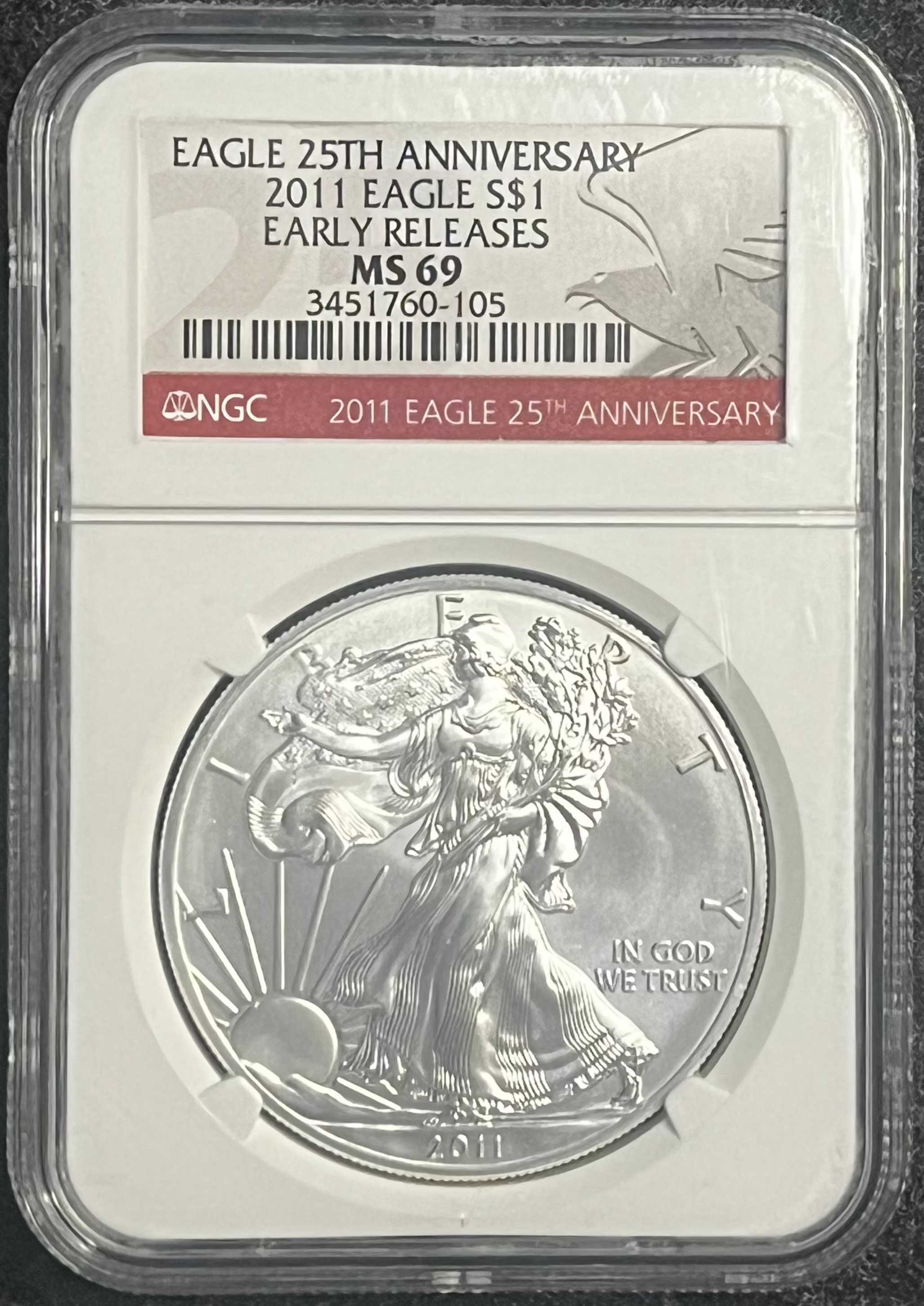 Silver eagle coin in a protective holder on a dark background