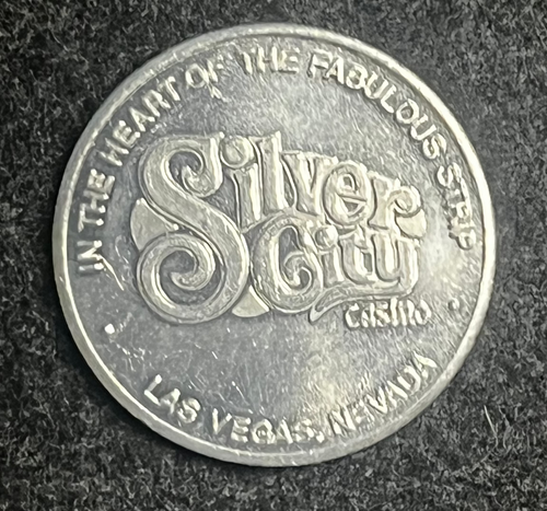Silver coin with 'Silver Slipper Casino' text on a dark textured surface